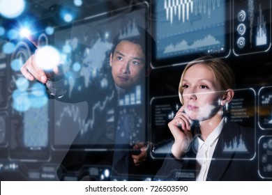 Two Business Persons In Front Of Futuristic Display. Graphical User Interface(GUI). Head Up Display(HUD). Internet Of Things.