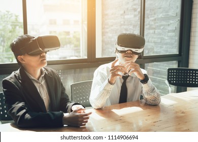 Two business business persons with virtual reality headsets in the office. - Powered by Shutterstock