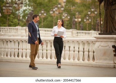 Two Business Poeple Are Walking Together While Talking About Their Company