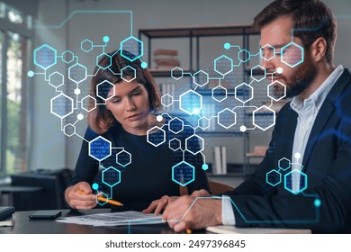 Two business professionals analyzing documents with a futuristic technology overlay in a modern office. Concept of data analysis and digital interaction