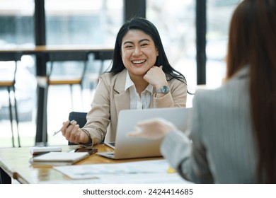 Two business professionals engaged in a serious discussion, possibly conducting a job interview in a modern office environment. - Powered by Shutterstock