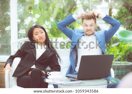 Two business surprised looking at laptop computer with shocked, businessman and businesswoman contract with excited in meeting teamwork.