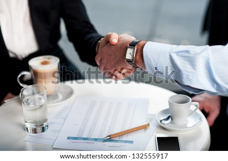 Two business tycoons meet over a coffee and closed long-term deal.