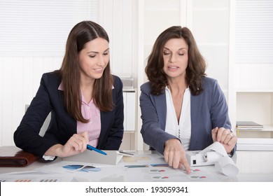 Two Business Woman Analyzing Balance Sheet.