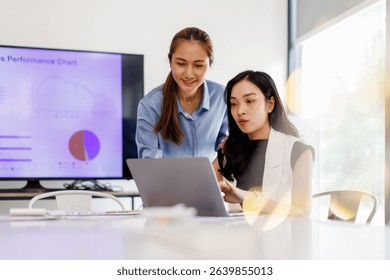  Two business woman lawyer or company employee holding accounting bookkeeping documents checking financial data or marketing report working in office with laptop. Paperwork management
