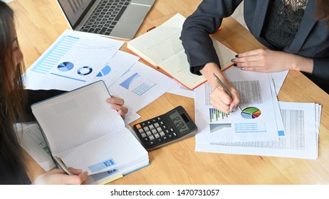 Two business woman working with analysis finance data on digital tablet and paper with top view. - Shutterstock ID 1470731057