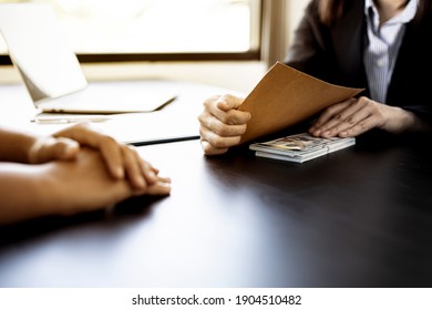 Two business women are doing fraud by handing over bribes, business partners give money to businessmen to defraud the company, bribery is illegal. The concept of corruption. - Shutterstock ID 1904510482