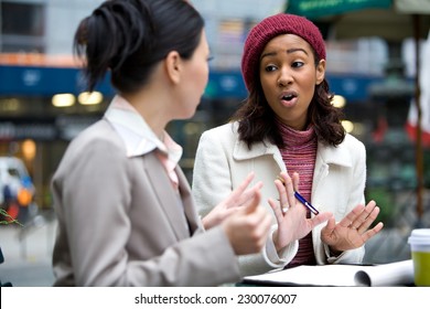 Two Business Women Having A Casual Meeting Or Discussion In The City. Shallow Depth Of Field.