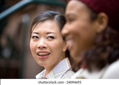 Two Business Women Having A Casual Meeting Or Discussion In The City. Shallow Depth Of Field.