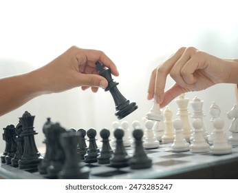 Two business women play chess and move chess pieces. Business management competition and leadership concepts.