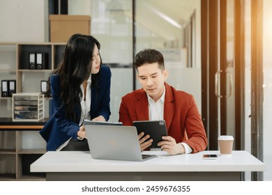 Two business workers talking on the smartphone and using laptop at the modern office.
 - Powered by Shutterstock