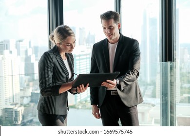 Two Businessman And Businesswoman Couple Meeting In Co Working Space At Sky Lounge