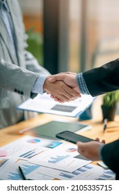 Two Businessman Handshake For Teamwork Of Business Merger And Acquisition At Office.