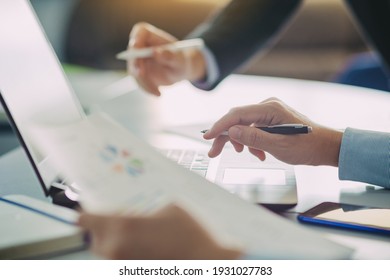 Two businessman investment consultant analyzing company financial report balance sheet statement working with documents graphs. Concept picture for stock market, office, tax, and project.