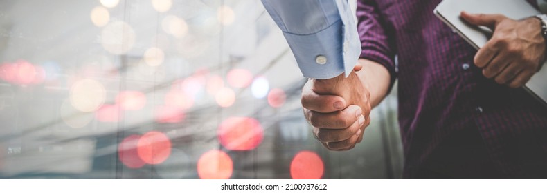 Two businessman shaking hands with business deals and congratulations on success, panorama image use for cover design.