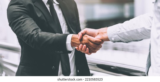 Two businessman shaking hands, business deals and congratulations on success concept.  - Shutterstock ID 2210583523