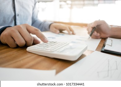 two businessman working together with financial report - Shutterstock ID 1017334441
