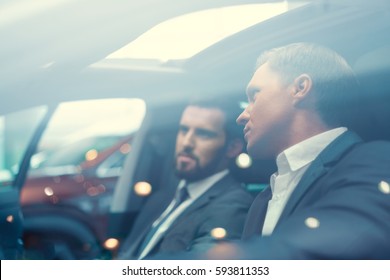 Two Businessmen In Car