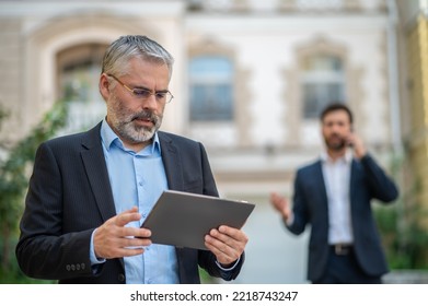 Two Businessmen Discussing A Project