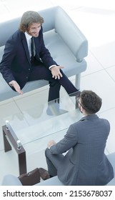 Two Businessmen Discussing In The Workplace