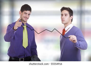 Two Businessmen Drawing A Graph In The Office.