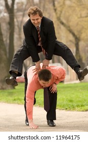 Two businessmen  jumping, playing leapfrog