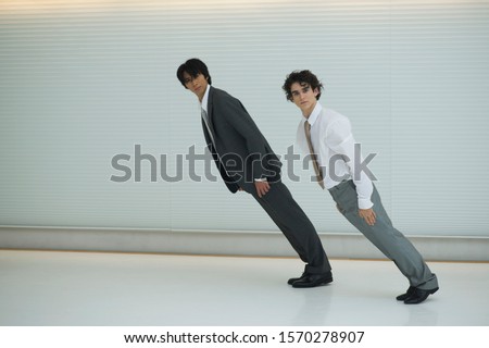 Two businessmen leaning forward at a slant