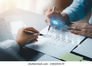 Two businessmen are meeting together, they point to financial documents to discuss plans and solutions, chart graphics showing financial status and performance. Business administration concept. - Shutterstock ID 2181053173