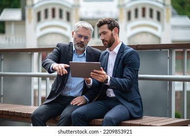 Two Businessmen Negotioating Regarding New Property And Looking Interested