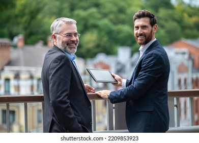 Two Businessmen Negotioating Regarding New Property And Looking Interested