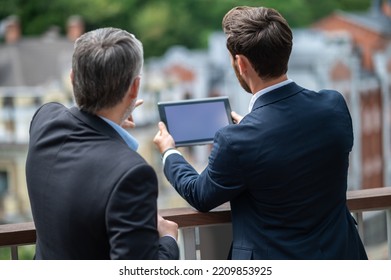 Two Businessmen Negotioating Regarding New Property And Looking Interested