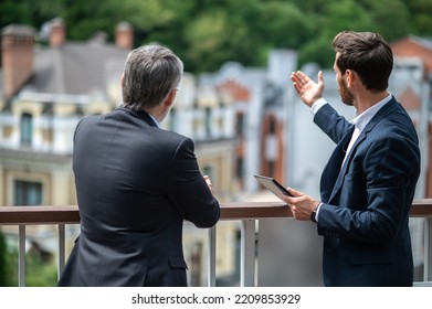 Two Businessmen Negotioating Regarding New Property And Looking Interested