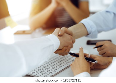 Two Businessmen Shaking Hands In Sunny Office, Close-up. Colleagues Applauding Of Success Meeting End