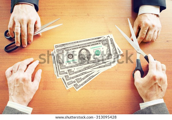Two\
businessmen share profits. Conceptual\
image
