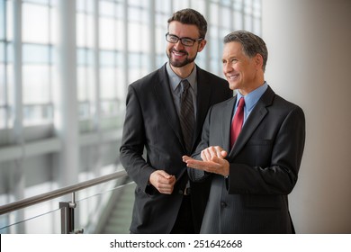 Two Businessmen Smiling At The Office