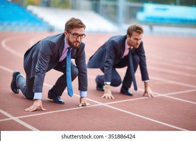 Two Businessmen Standing At Start On Stadium