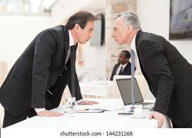 Two businessmen are trying to come to an agreement.