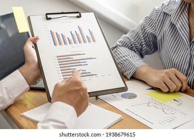 Two Businessmen Are Working In A Meeting Room, They Are Documenting The Company's Finances And Verifying The Accuracy Of The Information To Bring Them To The Shareholder's Meeting. Financial Concept.