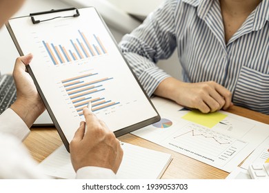 Two Businessmen Are Working In A Meeting Room, They Are Documenting The Company's Finances And Verifying The Accuracy Of The Information To Bring Them To The Shareholder's Meeting. Financial Concept.