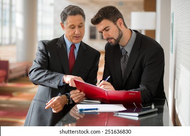 Two Businessmen Working At The Office 