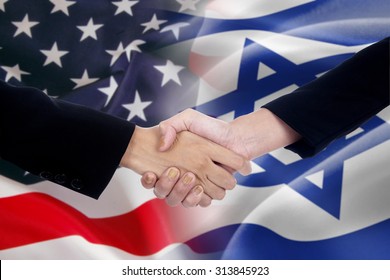 Two businesspeople shaking hands after good deal in front of the the american and israel flags - Powered by Shutterstock