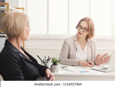 Two businesswoman working. Enterpreneurs discussing new work project sitting in modern office - Shutterstock ID 1116927404