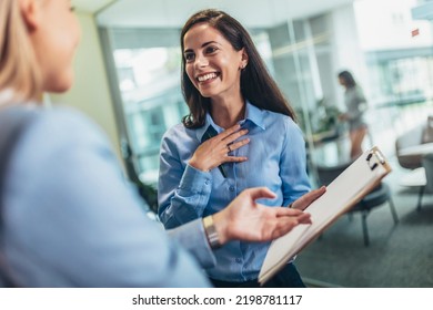 Two Businesswomen Talking In The Office