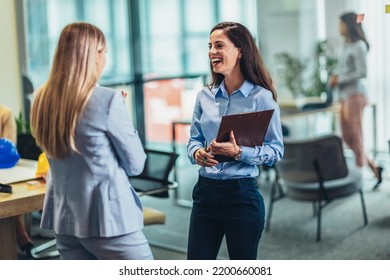 Two Businesswomen Talking In The Office