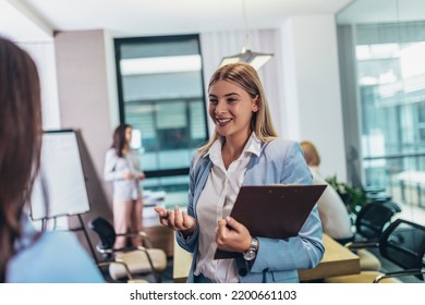 Two Businesswomen Talking In The Office