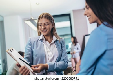 Two Businesswomen Talking In The Office