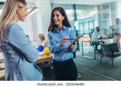 Two Businesswomen Talking In The Office