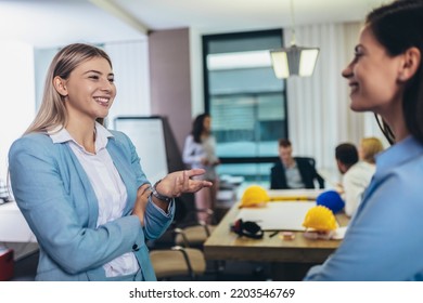 Two Businesswomen Talking In The Office