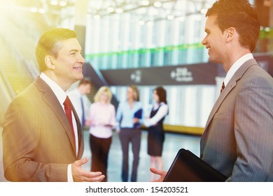 Two Bussiness Men Partners Over Team Background