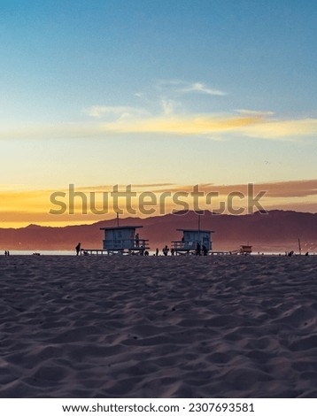 Two californian lifeguard towers at sunset